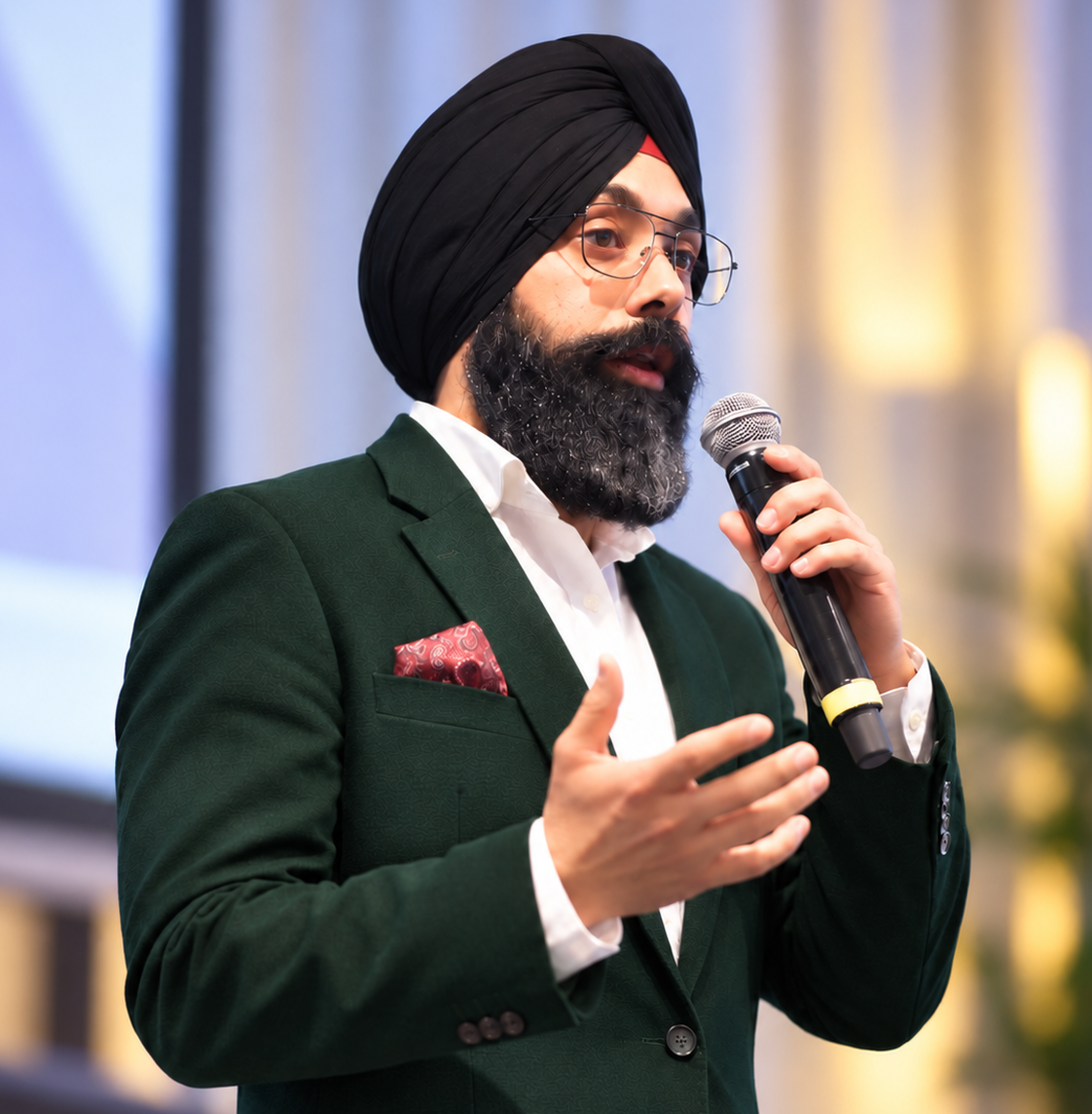 Navdeep Chhabra speaking into a microphone, facing the coaching pathway details.